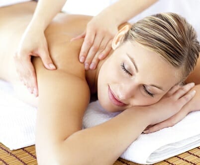 Relaxed smiling woman receiving a back massage