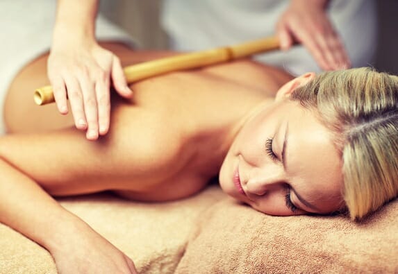 close up of woman lying and having massage in spa